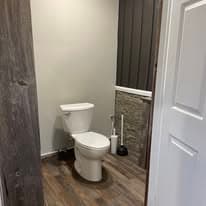 Restroom with stone accent wall, clean and modern finishes
