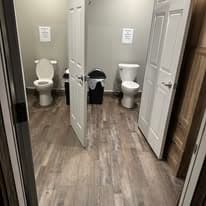Hallway view showing two restroom stalls