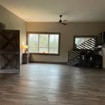Studio with barn-door accent wall and modern metal staircase railing