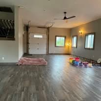Studio wide shot with ceiling fan and natural light through large windows