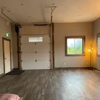 Studio angle showing overhead garage-style door and floor lamp