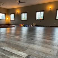Studio wide shot with wall sconces lit, windows, and singing bowls